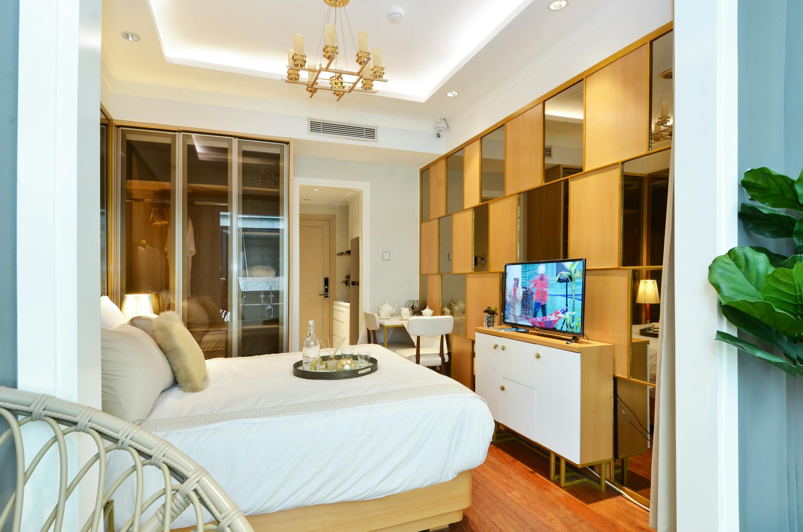 Luxurious hotel room featuring modern interior design with a comfortable bed, stylish furnishings, and ambient lighting.